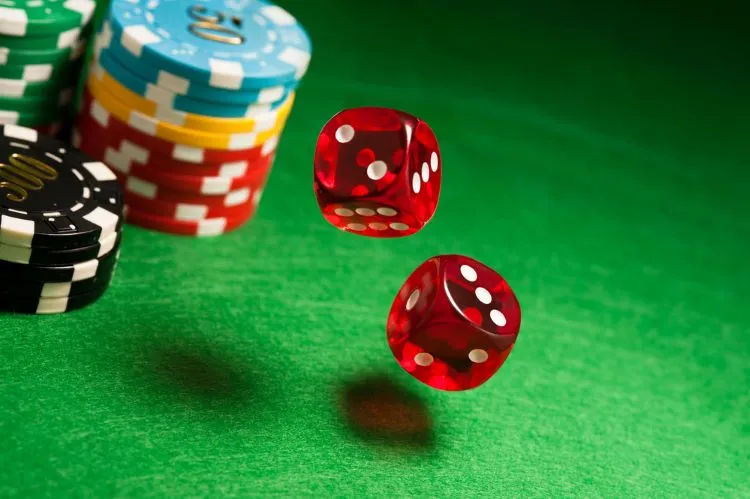 dices and casino chips on a table